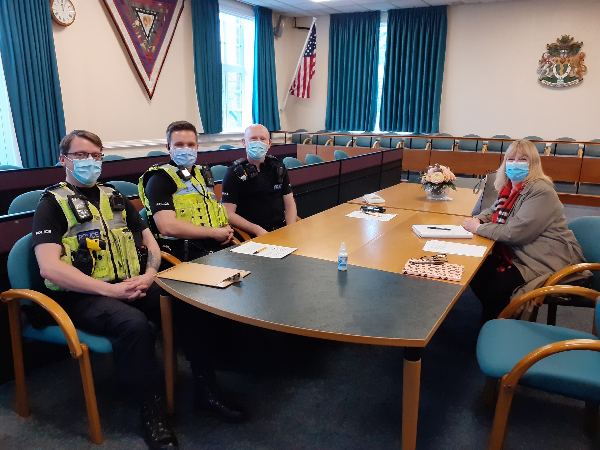 Three Policemen sat at a table with Ripley Town Clerk in the Council Chamber at Amber Valley Borough Council