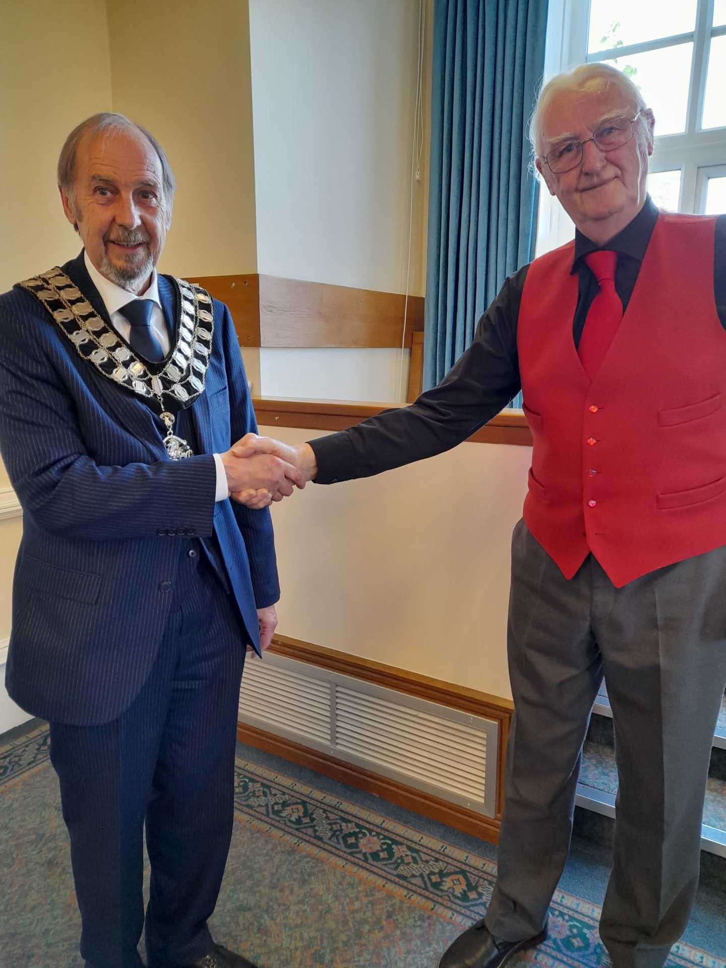 Ripley Mayor Councillor Paul Lobley BEM receiving the Mayoral chain from the former Mayor, Cllr Nigel Weaving.